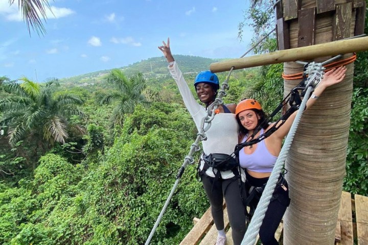 a person standing on top of a wooden bridge